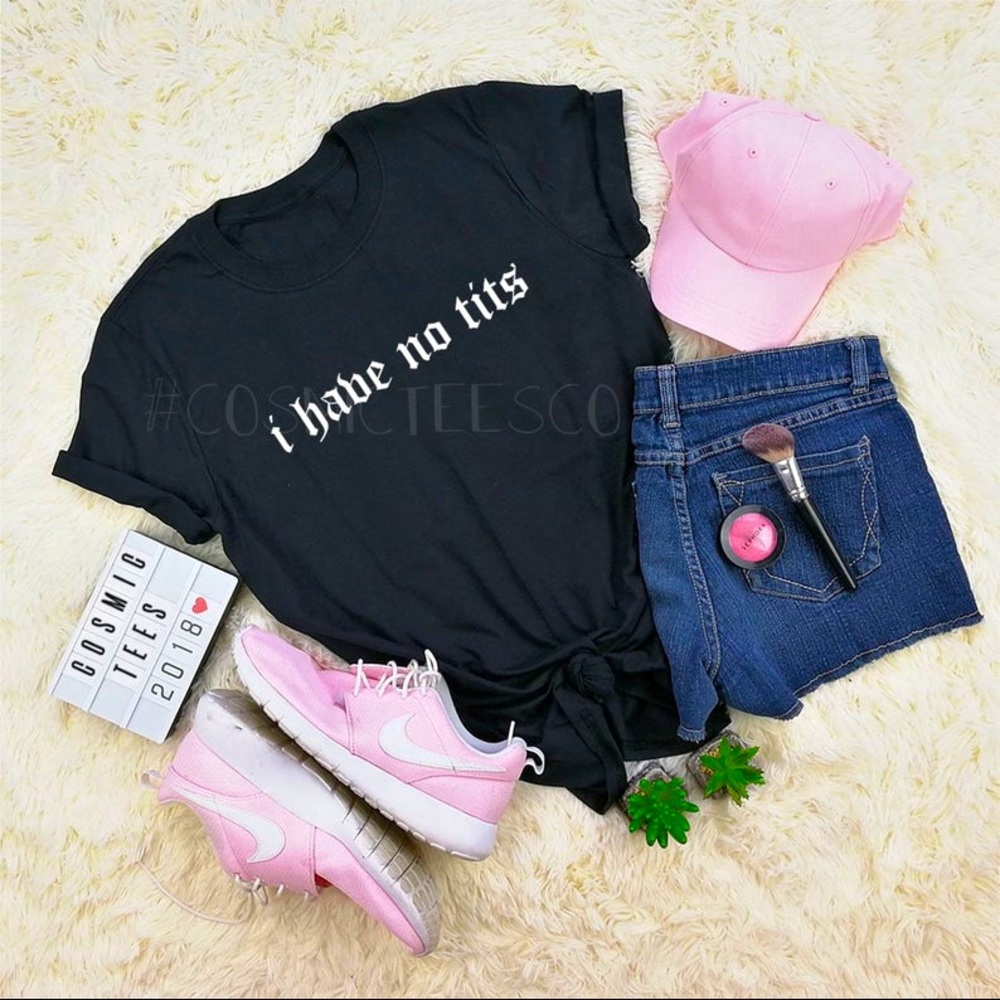 White shirt with black font “I have no tits”